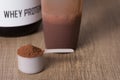 Whey Protein. White scoop with chocolate flavour powder, shaker Royalty Free Stock Photo