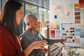 Which colour would be better. two female designers working in an office. Royalty Free Stock Photo