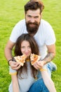 Which is your favorite. Fast food. Bearded man feeding woman cheesy pizza. Couple in love dating outdoors eat pizza Royalty Free Stock Photo