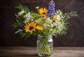 A whimsical arrangement of wildflowers in a mason jar.