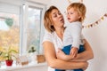 A whimsical child. A young mother hugs and comforting her crying baby. The concept of parenting Royalty Free Stock Photo