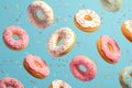 Whimsical delight pink donuts with colorful sprinkles on blue background