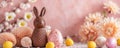 A whimsical display of Easter treats, with a chocolate bunny centerpiece among eggs and seashells against a pink floral