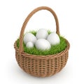 Whimsical easter basket filled with white eggs nestled in green grass Royalty Free Stock Photo