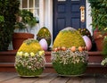 Whimsical Easter egg topiaries arranged at the entrance of a quaint garden party Royalty Free Stock Photo