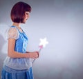 Whimsical, fairy and woman with wand of magic and lighting for fantasy in grey background. Adult, female person and girl Royalty Free Stock Photo