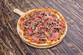 whimsical italian pizza recipe with prosciutto, mushrooms and tomatoes