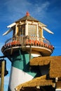 A whimsical lighthouse stands at a nautical themed store