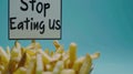 Whimsical plea: cartoon characters, fast food holding a sign 'Stop Eating Us.' A playful take on the concept of Royalty Free Stock Photo