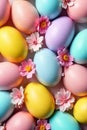 A whimsical scene of candy and Easter eggs arranged on a pastel colored wooden surface. A top down, flat Royalty Free Stock Photo