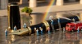 Miniature Workers Cleaning a Giant Fountain Pen with Fire Truck and Rainbow Royalty Free Stock Photo