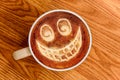 Whimsical Smiley Face Latte Art on Wood Surface