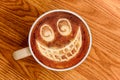 Whimsical Smiley Face Latte Art on Wood Surface Royalty Free Stock Photo