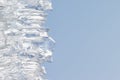 Whimsical surface ice closeup on blue sky background. Royalty Free Stock Photo