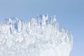 Whimsical surface ice closeup on blue sky background. Royalty Free Stock Photo