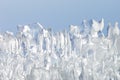 Whimsical surface ice closeup on blue sky background.