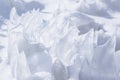 Whimsical surface ice with snow closeup on blue sky background. Royalty Free Stock Photo