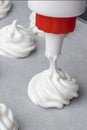 Whipped cream on baking paper. Meringue of the proteins and sugars.