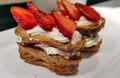 Whipped cream cake decorated withfresh strawberries wedges