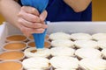 whipped cream piped on to tray of sponge cakes Royalty Free Stock Photo