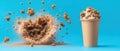 Whipped cream topping explodes from a paper cup with granular food particles scattering dramatically against a blue background, a Royalty Free Stock Photo