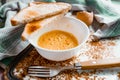 Whipped with a fork and mixed raw egg broken into a white bowl with yolk and protein, next to the shell, fork and towel Royalty Free Stock Photo