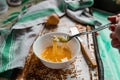 Whipped with a fork and mixed raw egg broken into a white bowl with yolk and protein, next to the shell, fork and towel Royalty Free Stock Photo