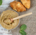 Whipped honey with apricot on a table in a jar with a spoon spindle, next to croissants and mint, top view Royalty Free Stock Photo