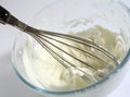 Whipping cream in a glass bowl