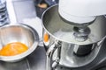 Whipping egg whites in professional kitchen`s mixer