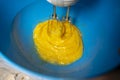 Whipping eggs with a hand mixer. Close-up
