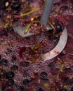 Whipping grapes with a mixer in a barrel, the process of making homemade wine