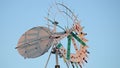 A whirligig spins in the daylight.