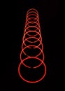 Whirling red light circles on black background