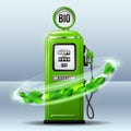 Whirlwind of green leaves swirls around Green bright Gas station pump with fuel nozzle of petrol pump. Royalty Free Stock Photo