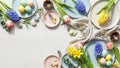 Easter table setting with colorful eggs and spring flowers Royalty Free Stock Photo