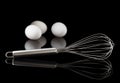 Whisk in front of tree eggs Royalty Free Stock Photo