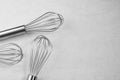 The whisk placed On the background is uneven white plaster Royalty Free Stock Photo