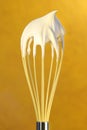 Whisk with whip cream on top Royalty Free Stock Photo