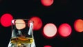 Whiskey on a background of red circles bokeh, background with a glass of whiskey Royalty Free Stock Photo