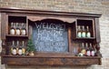 Whiskey bottles on display with welcome sign at distillery