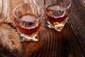 Whiskey, bourbon, brandy, or cognac on log table Royalty Free Stock Photo