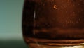 Whiskey, brandy or cognac pouring into glass. Stock clip. Close up of transparent glass and alcohol drink. Royalty Free Stock Photo