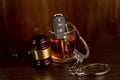 Whiskey with car keys and handcuffs. Concept for drinking and driving Royalty Free Stock Photo