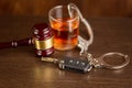 Whiskey with car keys and handcuffs. Concept for drinking and driving Royalty Free Stock Photo