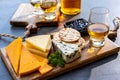 Whiskey and cheese pairing, tasting whisky glasses and plate with sliced cheeses