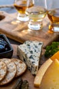 Whiskey and cheese pairing, tasting whisky glasses and plate with sliced cheeses