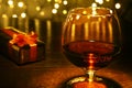 Whiskey, cognac, brandy and gift box on wooden table. Celebration composition on the light background. Royalty Free Stock Photo