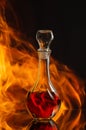 Whiskey in a decanter against a natural flame