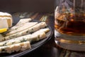 Whiskey in a glass and appetizer - blue cheese and camembert cheese.